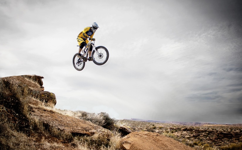 Mountain bike jumping over rocky terrain